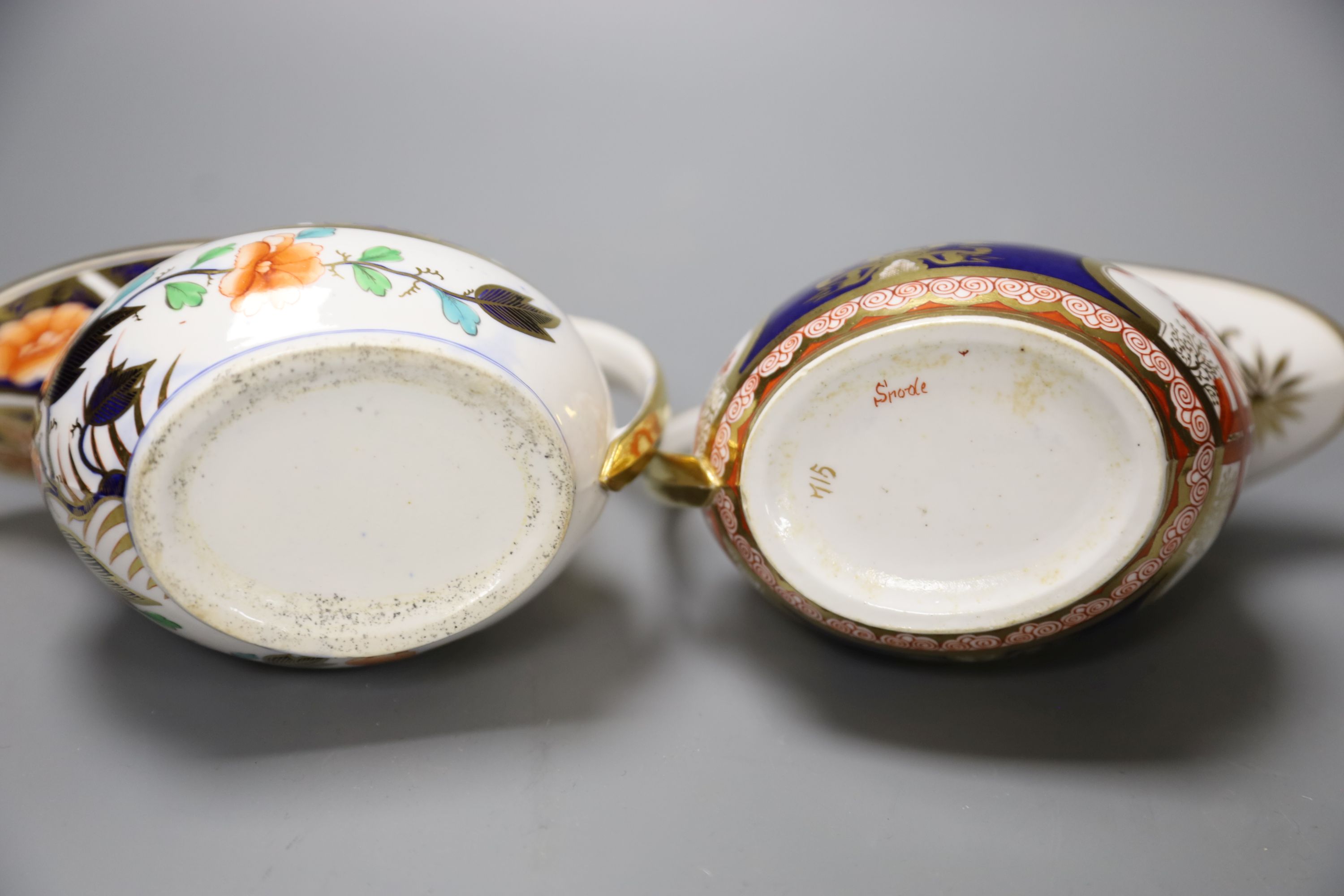 A Spode cream jug painted in imari style with the dollar pattern 715 and another Spode cream jug painted in imari style